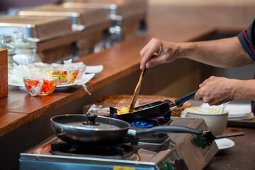 Cooking scrambled eggs on pan