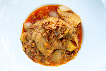 Massaman chicken curry on wooden table