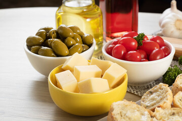 Appetizer jars with cheese, olives and cherry tomatoes
