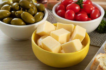 Appetizer jars with cheese, olives and cherry tomatoes
