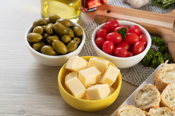 Appetizer jars with cheese, olives and cherry tomatoes