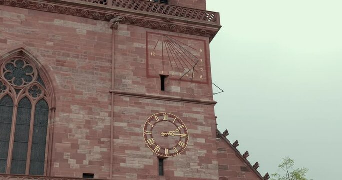 View from below of the Basler M&uuml;nster cathedral with a detail of the clock