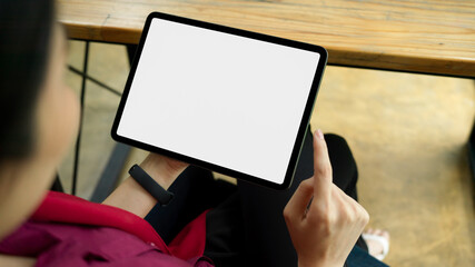 Top view, Blank screen tablet, woman sitting on armchair and using tablet