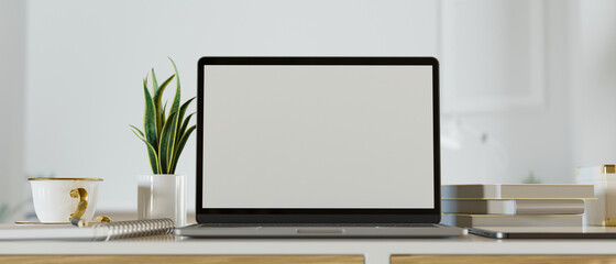 White screen laptop mockup image with office table accessories