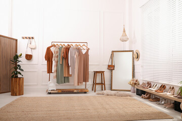 Dressing room interior with stylish clothes, shoes and accessories