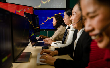 Teamwork of happy female trading marketing operators wears microphone headset sit smiling making bitcoin cryptocurrency stock exchange buy sell trading transaction from chart graph monitor in office