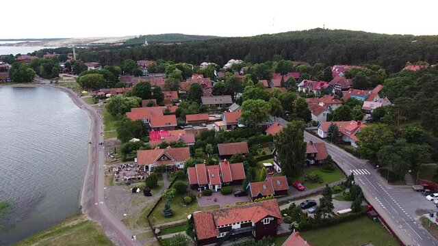 Nida town in Neringa, Lithuania in aerial drone ascending to high altitude view