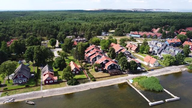 Vibrant and colorful town of Pervalka on sunny day, aerial orbit view