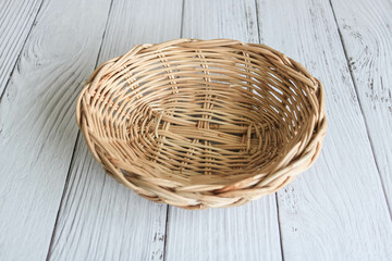 Fototapeta premium Empty weaved basket on the wooden table.