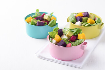 Fresh fruit and vegetable salad with avocado, dragon fruit, pumpkin, radish, lettuce and corn salad. Concepts of healthy food, vegetarian and lifestyle trends.