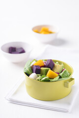 Fresh fruit and vegetable salad with avocado, dragon fruit, pumpkin, radish, lettuce and corn salad. Concepts of healthy food, vegetarian and lifestyle trends.