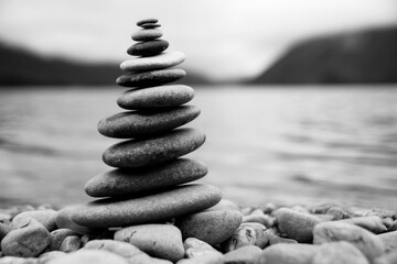 Zen Balancing Pebbles Next to a Misty Lake