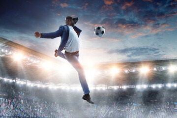 Fototapeta na wymiar Virtual Reality headset on a black male playing soccer. Mixed media