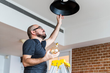 Man changing light bulb