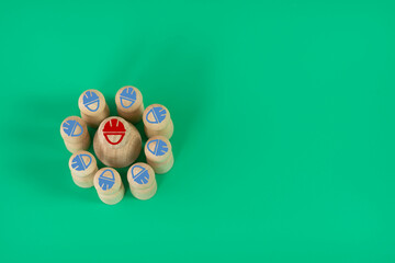 Business concept. Small wood model circling a single bigger wood model with icons symbolizing team...