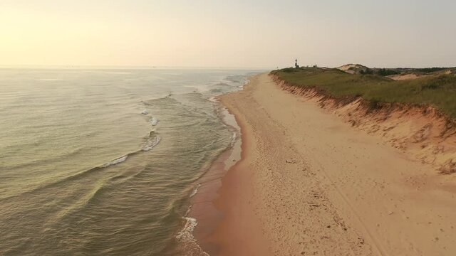 Sand dunes on the shore of Lake Michigan, beach at sunset. Ludington State Park, Michigan state, United States of America. Aerial view, from above, fly over