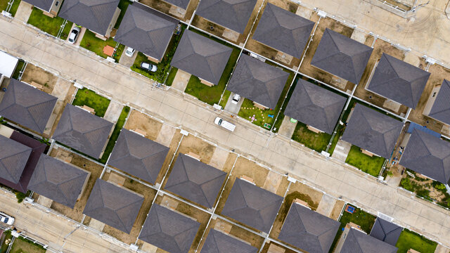Aerial top view over modern suburb housing estate project neighborhood, Thailand. Housing construction business.