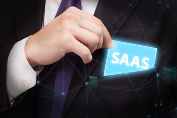 Business, technology, internet and network concept. Young businessman thinks over the steps for successful growth: SAAS