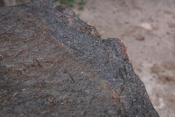 close up structure of splitted broken granite boulder stone. Surface is wet