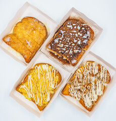 Sliced bread topping with chocolate,tuna mayonnaise, butter sweet condensed milk and dried shredded pork