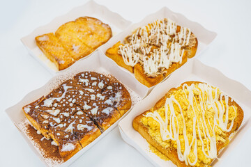 Sliced bread topping with chocolate,tuna mayonnaise, butter sweet condensed milk and dried shredded pork