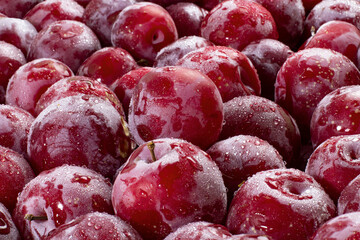Ripe red plums close-up as background or backdrop