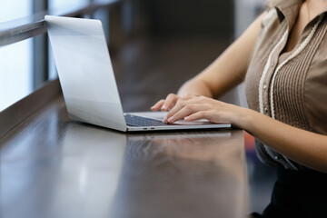 Fototapeta premium Woman with blond hair using with computer laptop at office table. professional freelancer in workplace.