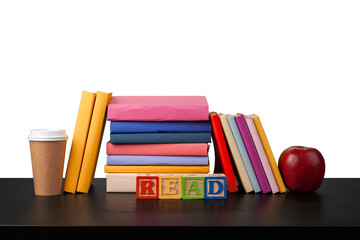Stack of books and apple on tabletop against white background