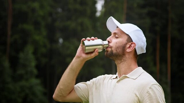 Young golfer drinking water from a bottle