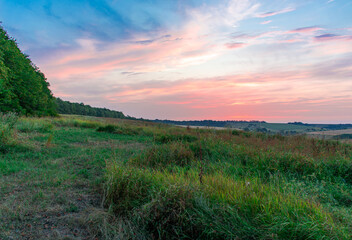 Beautiful summer landscape, sunset or sunrise over the plain