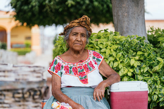 serious merchant woman looking at camera. Mexican old woman