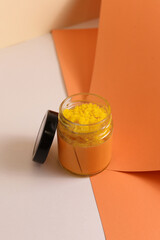 Body scrub of sea salt with lemon, rosemary and olive oil in glass jar on stone table, homemade cosmetic for Spa care