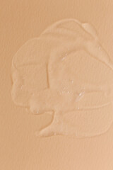 Cream gel transparent cosmetic sample texture isolated on beige background