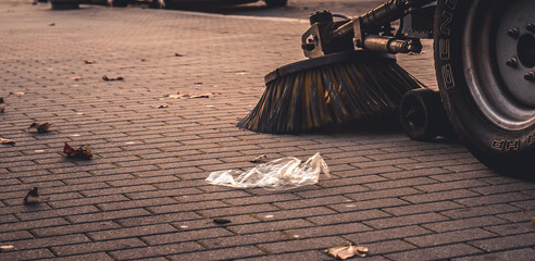 Sweeper machine in the process of cleaning the street.. Municipal service cleans the city.