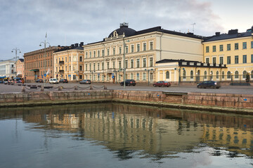 View of Pohjoessplanadi street in Finnish Helsinki near Kauppatori with blurred reflection in the water.