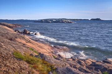 The coast of Porkkala in the evening of a summer day waves the stones of the island.