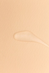 Cream gel transparent cosmetic sample texture isolated on beige background