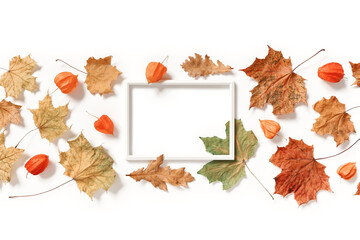 Blank photo frame, physalis flowers, dried maple and oak leaves isolated on white background. Autumn, fall, thanksgiving day concept. Flat lay. Top view. Copy space.