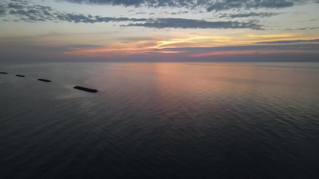 Lake Erie sunset in Erie, Pennsylvania with drone shot moving down over water.