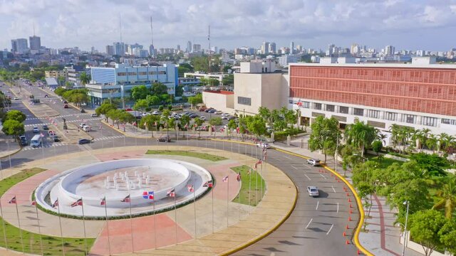 Roundabout with flags at Congress of the Dominican Republic, Jimenez Moya Avenue, Santo Domingo, aerial pan shot
