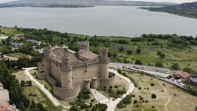 Point of view aerial over the Castle of the Mendoza in Manzanares el Real - Spectular lake and landscape backdrop. 