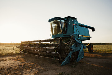 Blue combine harvester agriculture machine harvesting in a field