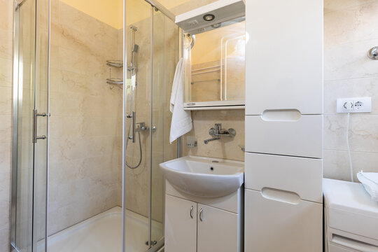 Tiled bathroom interior with shower cabin