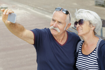 a senior couple taking selfie