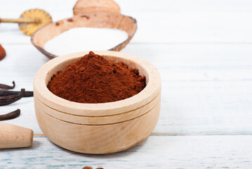 pile of cocoa powder, sugar and dessert ingredients, kitchen utensils on old white wooden