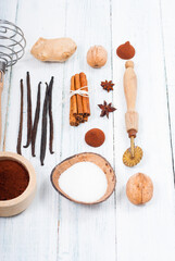 dessert ingredients and kitchen utensils on old white wooden table
