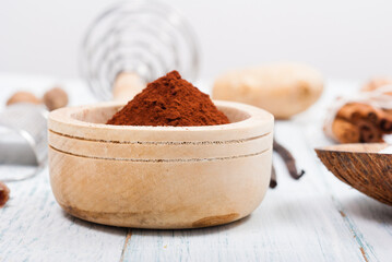 pile of cocoa powder, sugar and dessert ingredients, kitchen utensils on old white wooden