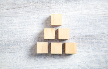 Wooden cubes on white wooden background.