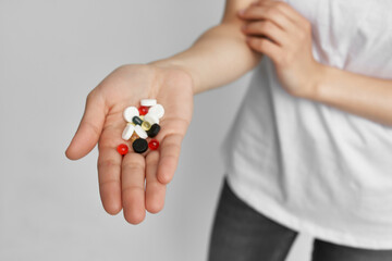 colorful pills in the palm of your hand pain reliever health treatment pharmacology