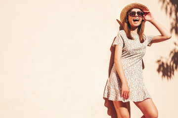 Young beautiful smiling hipster woman in trendy summer sundress. Sexy carefree woman posing in the...